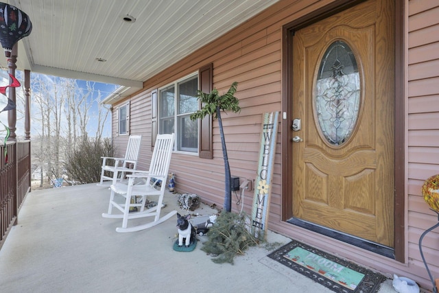 view of exterior entry with covered porch