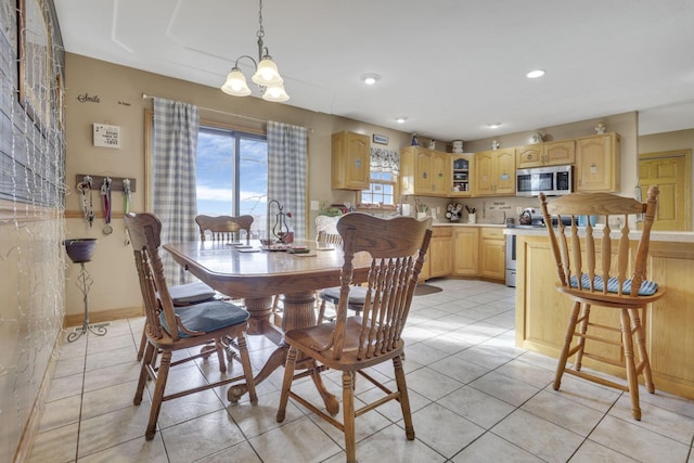 dining room featuring light tile patterned floors, plenty of natural light, a chandelier, and recessed lighting