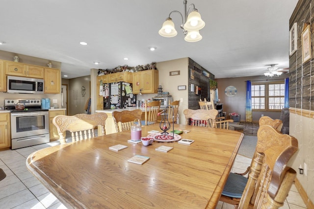 dining room with light tile patterned floors, recessed lighting, and ceiling fan with notable chandelier