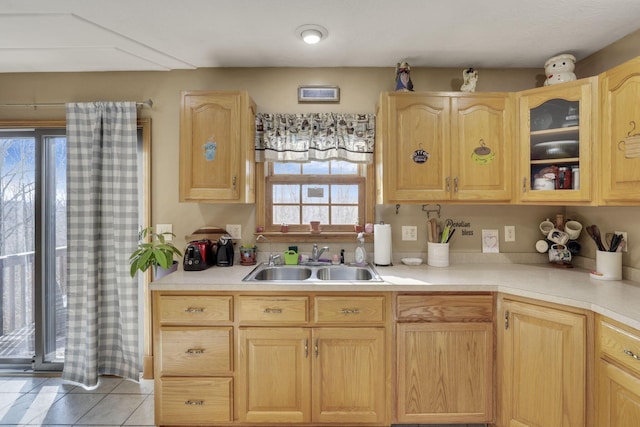 kitchen with light brown cabinets, light countertops, and a sink