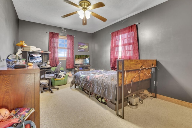 bedroom with carpet floors, a textured ceiling, baseboards, and a ceiling fan