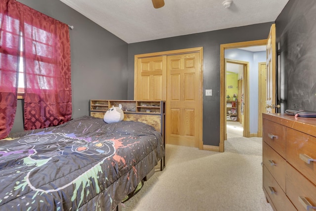 bedroom with baseboards, ceiling fan, and light colored carpet