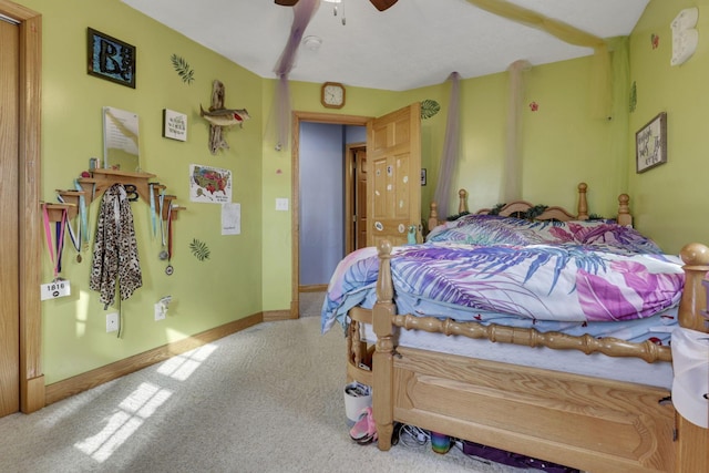 carpeted bedroom featuring ceiling fan and baseboards