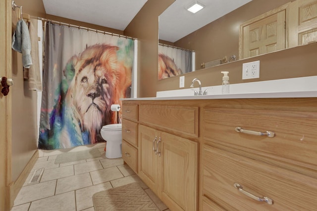 full bathroom featuring toilet, tile patterned flooring, and vanity