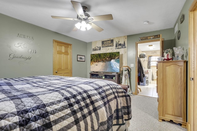 bedroom featuring light carpet and ceiling fan