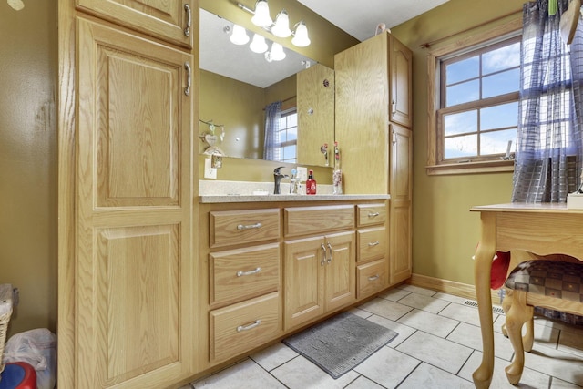 bathroom featuring vanity, tile patterned flooring, and a wealth of natural light