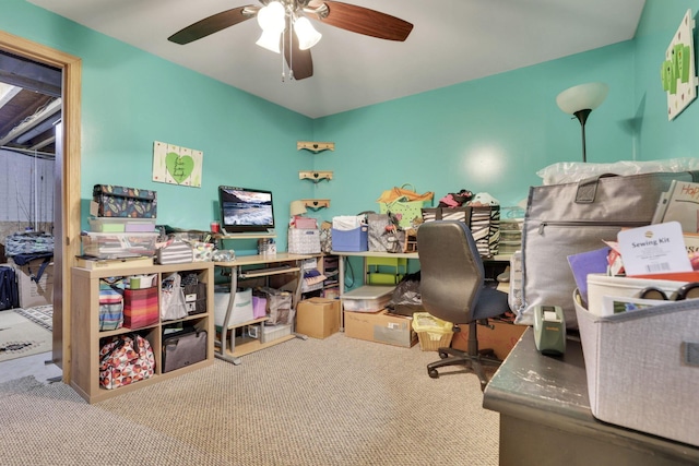 office area with a ceiling fan and carpet flooring