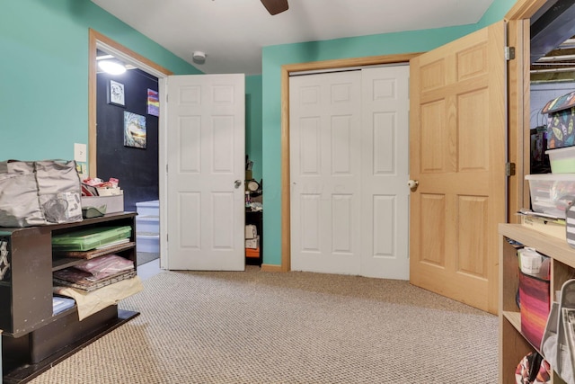 carpeted bedroom with a ceiling fan and a closet