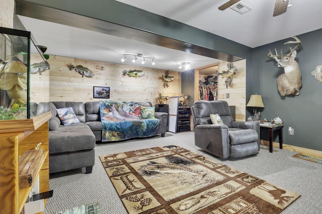 living room with carpet, visible vents, ceiling fan, and baseboards