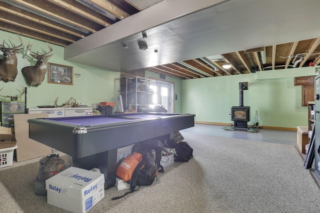 game room with a wood stove, pool table, and concrete floors