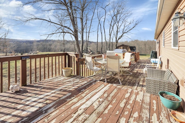 wooden terrace with outdoor dining space