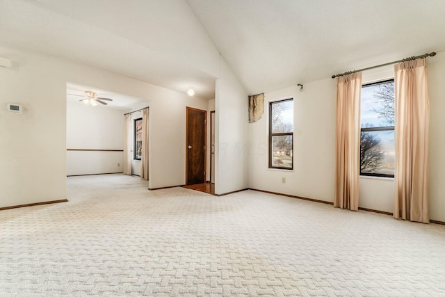 unfurnished room featuring lofted ceiling, carpet floors, and ceiling fan