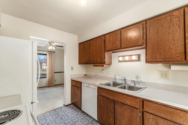 kitchen with sink, white appliances, ceiling fan, a textured ceiling, and light colored carpet