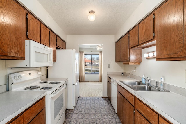 kitchen featuring ceiling fan, sink, a textured ceiling, and white appliances