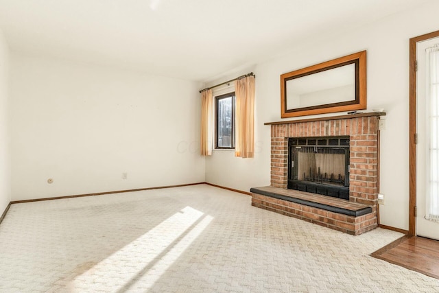 unfurnished living room with light carpet and a fireplace