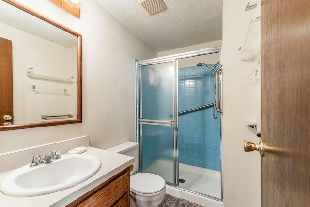 bathroom with vanity, an enclosed shower, a textured ceiling, and toilet