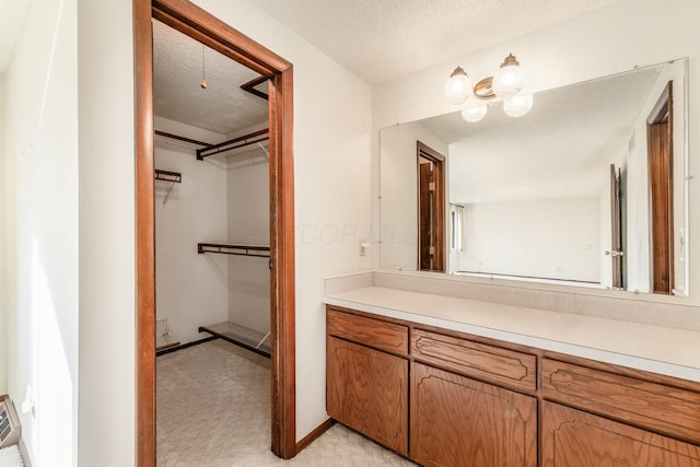 bathroom with vanity and a textured ceiling