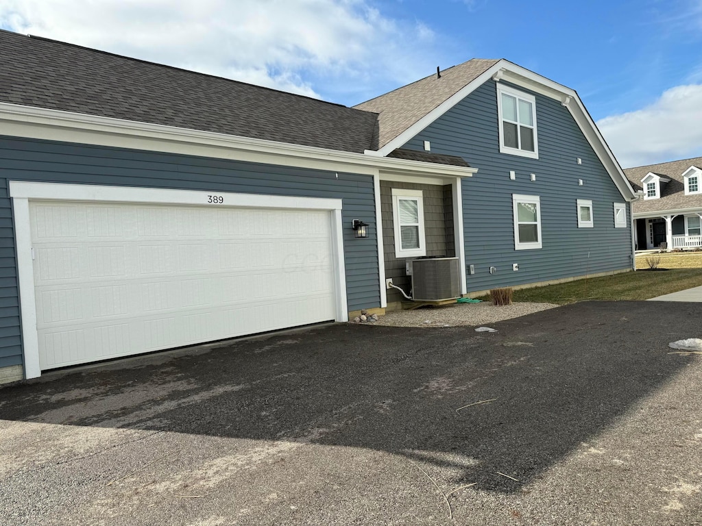 exterior space featuring a garage and central air condition unit