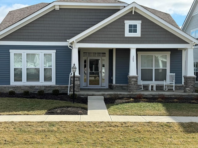 craftsman house featuring a front yard and covered porch