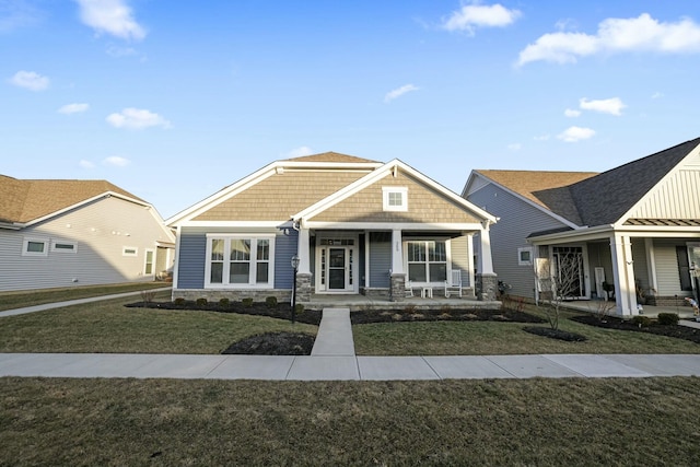 craftsman-style house featuring a porch and a front yard