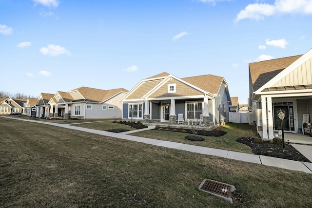 view of front of property featuring a front yard and covered porch