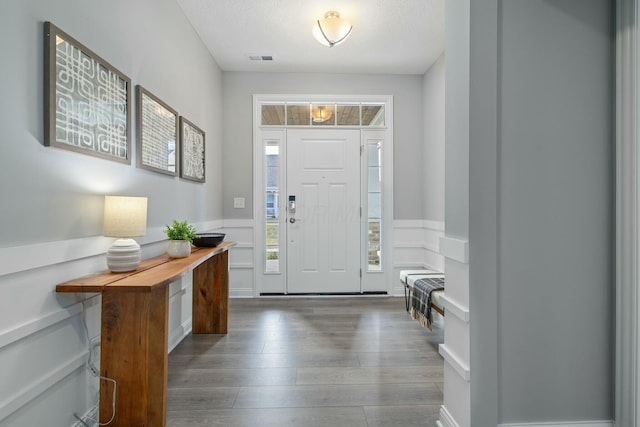 entryway featuring dark hardwood / wood-style flooring and a textured ceiling