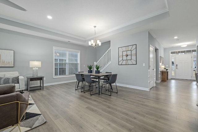 dining room with crown molding, a chandelier, and light wood-type flooring