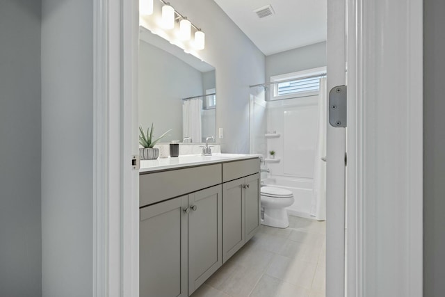 full bathroom featuring vanity, tile patterned floors, shower / bath combination with curtain, and toilet