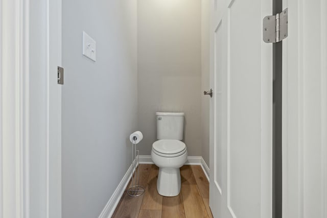 bathroom featuring hardwood / wood-style flooring and toilet