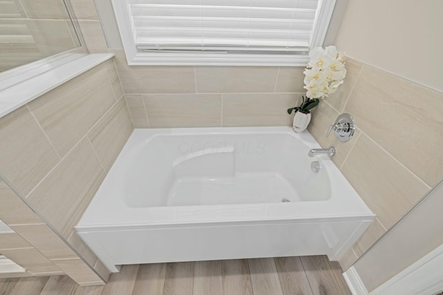 bathroom featuring hardwood / wood-style floors and a bathing tub