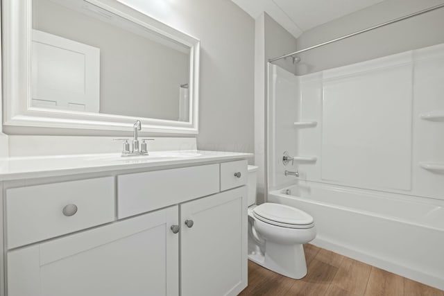 full bathroom with shower / bathtub combination, vanity, toilet, and hardwood / wood-style floors