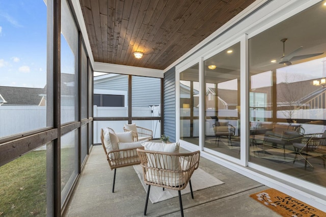 sunroom / solarium featuring wood ceiling and ceiling fan