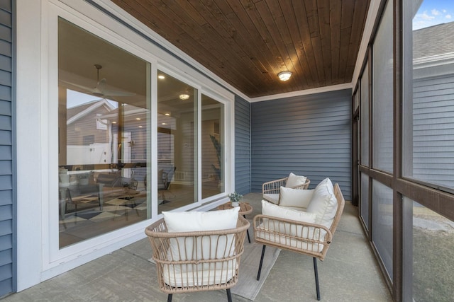 sunroom / solarium with wooden ceiling and ceiling fan