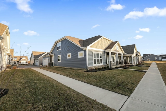 view of home's exterior featuring a garage, a yard, and central AC