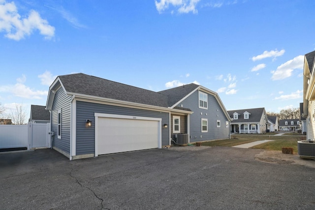 view of front of home featuring a garage and central AC unit