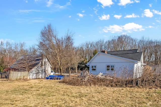 view of side of home featuring a lawn