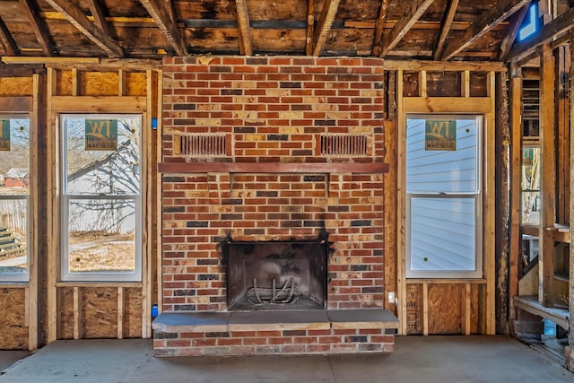 unfurnished living room featuring a brick fireplace