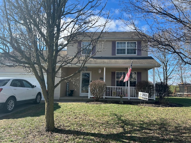 front facade featuring a porch, a trampoline, and a front lawn