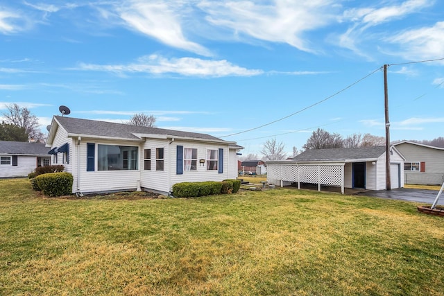 view of front of home with an outbuilding, a garage, and a front lawn