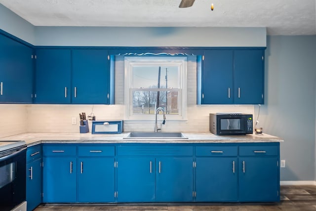 kitchen featuring range with electric cooktop, sink, backsplash, and blue cabinetry