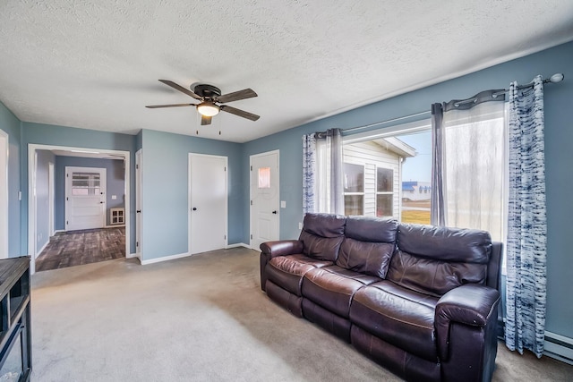 carpeted living room featuring a textured ceiling and ceiling fan