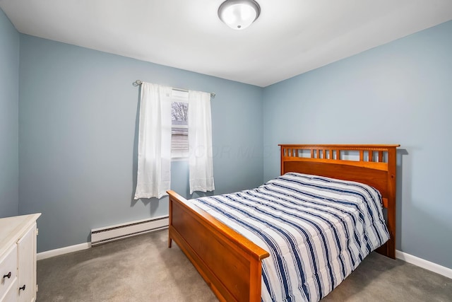 bedroom with carpet floors and a baseboard heating unit