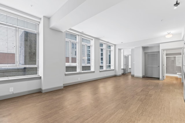 unfurnished living room with light wood-type flooring