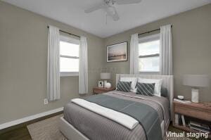 bedroom with ceiling fan, dark hardwood / wood-style flooring, and multiple windows