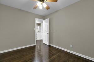 unfurnished room with ceiling fan and dark hardwood / wood-style floors