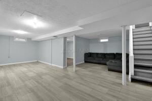 basement with light hardwood / wood-style flooring