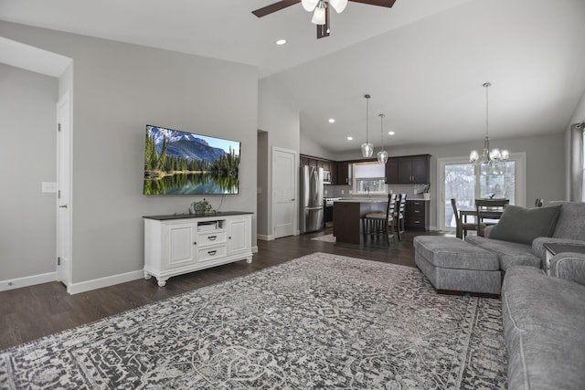 living room featuring dark wood-type flooring, high vaulted ceiling, and ceiling fan with notable chandelier