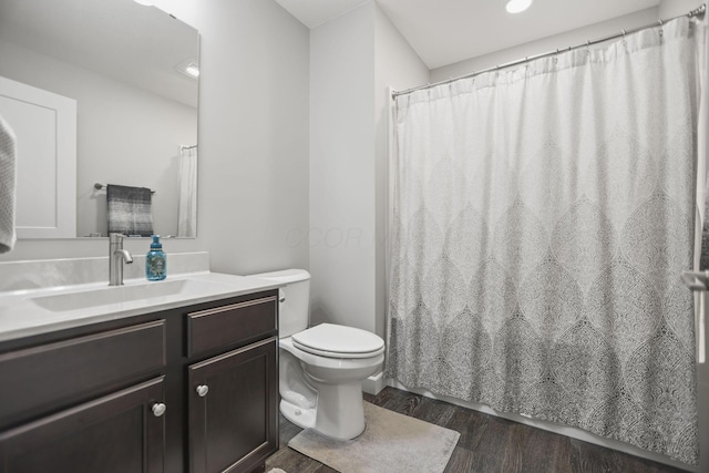 bathroom featuring vanity, hardwood / wood-style floors, and toilet