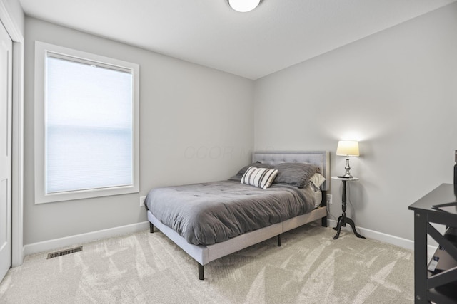 bedroom featuring light carpet