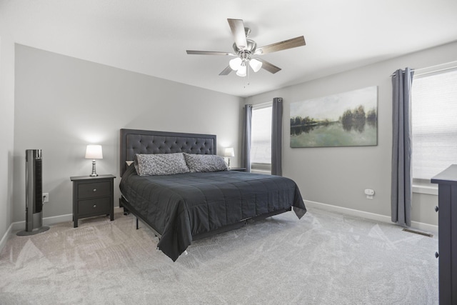 bedroom featuring light colored carpet and ceiling fan